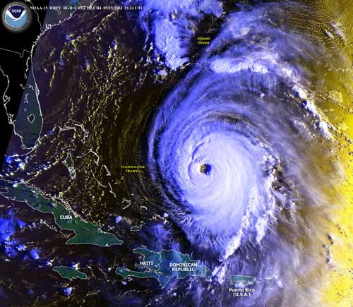 Visible imagery, Hurricane Isabel in the Atlantic Ocean, September 15, 2003. The image was taken as the sun rises, coloring the right side of the image.