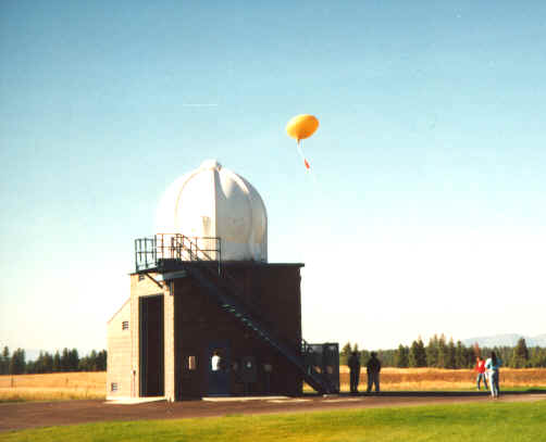 A 1997 radiosonde release (orange balloon) outside a NWS balloon inflation shelter.
