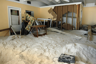 The storm surge of Hurricane Ivan (2004) pushed sand off of the shore of Pensacola Beach and into this Florida house.